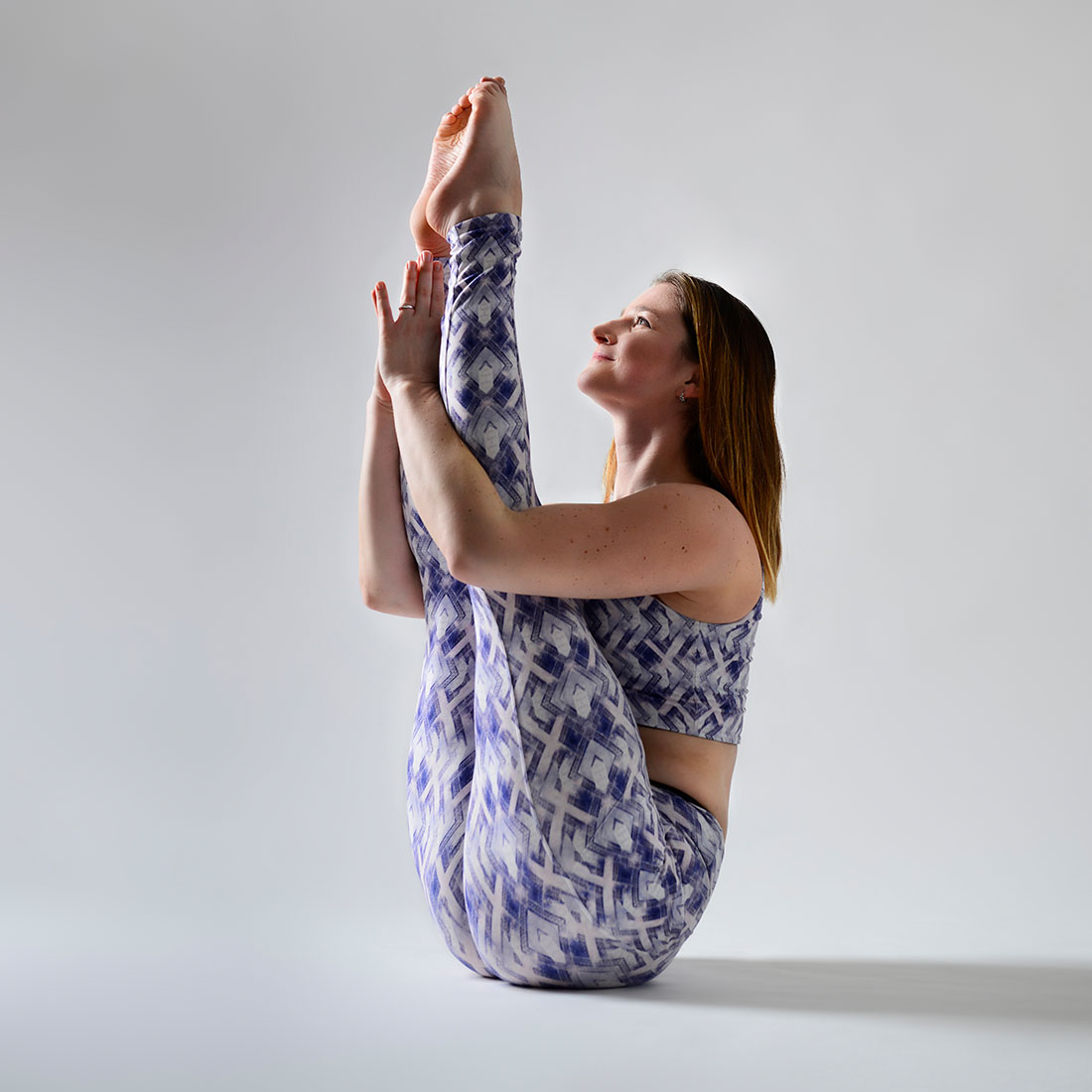 yoga teacher in boat pose during class at london dance academy