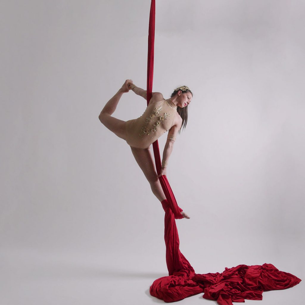 teacher demonstrating move in aerial silks lesson at london dance academy