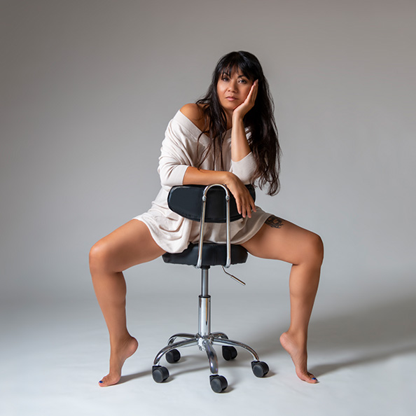 Melissa Gray, CEO and splits teacher at London Dance Academy, posing on chair