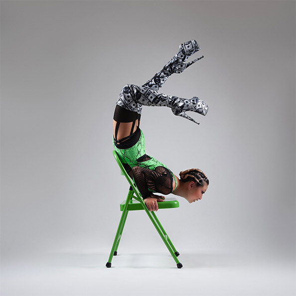 Yin Lee, pole dance teacher at London Dance Academy posing on chair